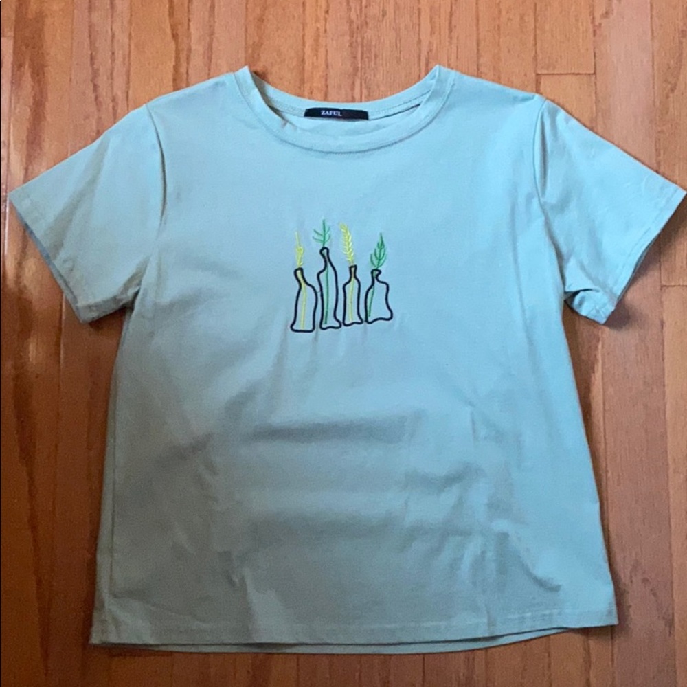 green/blue shirt sleeve with design